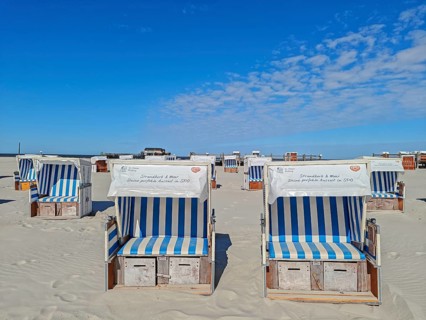 Preparing for the high season on the beach, setting up the beach chairs, North Sea, on the edge of