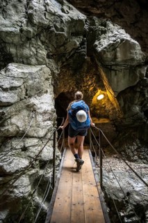 Hiker in a tunnel, Hammersbach flows through Höllentalklamm, near Garmisch-Partenkirchen,