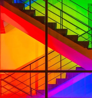 View through the windows of a brightly lit staircase. Frankfurter Mainova AG building, city center,