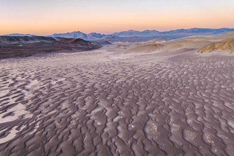 Vast pumice field under a clear sky in Catamarca, Argentina, showcasing textured volcanic rock