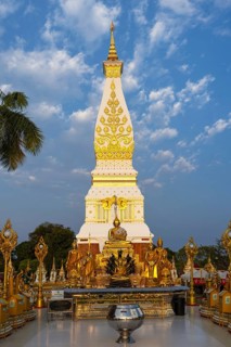 Chedi decorated with golden ornaments at Wat Phra That Phanom at sunrise, temple complex in Amphoe