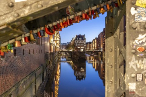 Water castle in Hamburg's Speicherstadt at blue hour with love locks in the foreground and