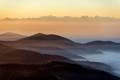 View from Belchen heading south of Wiesental and the Swiss Alps, morning atmosphere with fog in