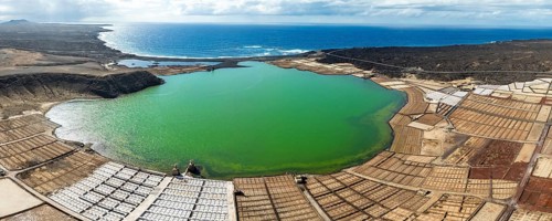 Salt mining plant, Salinas de Janubio with green Laguna de Janubio, near Yaiza, aerial view,