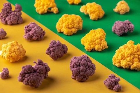 Colourful cauliflower on a yellow and green background