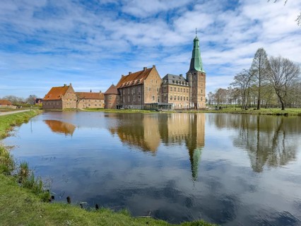 View over moat at historic moated castle from Renaissance Raesfeld Castle reflected in Wassergraben