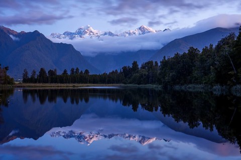 Lake Matheson (Te Ara Kairaumati) after sunset, reflection of the mountain peaks of Mount Cook and
