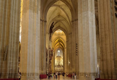 Long church corridor with imposing vault and rich architectural detail, Seville, Andalusia, Spain