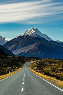 Stunning autumn view of Mount Cook, New Zealand, showcasing a serene landscape with a winding road