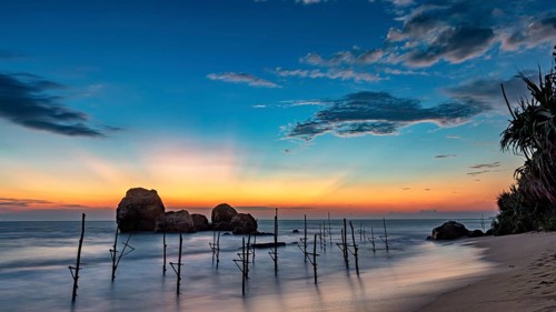 Blue twilight over the sea with wooden posts and quiet atmosphere, The stilt fishermen's beach near
