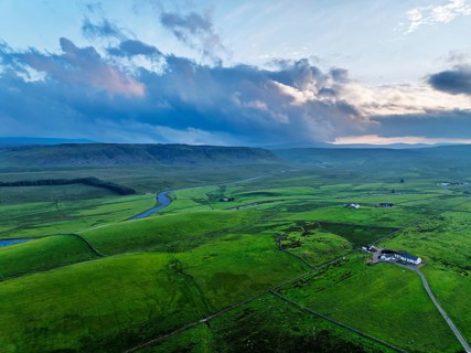 Forest in Teesdale over River Tees from a drone, North Pennines AONB, County Durham, England,