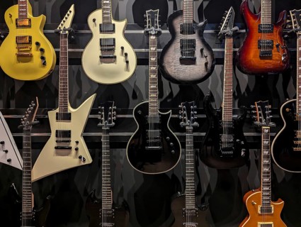 A vibrant selection of electric guitars showcased in a music store. The variety of designs and