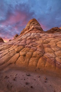 Vivid sunset over unique, textured sandstone formations at Coyote Buttes in the Paria