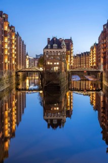 Water castle in Hamburg's Speicherstadt at the blue hour and reflection in the water, Hamburg,