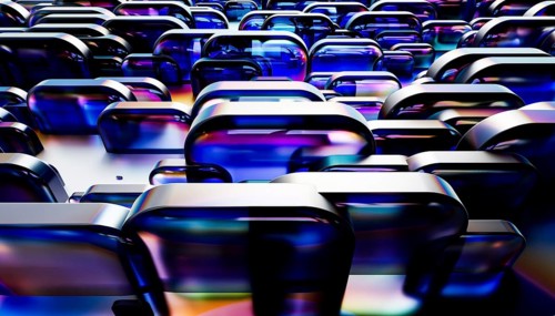 Abstract image of reflective, glass like structures with a vibrant mix of blue, purple, and