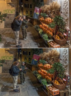 Tourists digitally photograph a vegetable stall in the old town and then check their bileders,