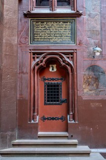 A distinctive door in the courtyard of Basel City Hall framed with late Gothic flooring and ornate
