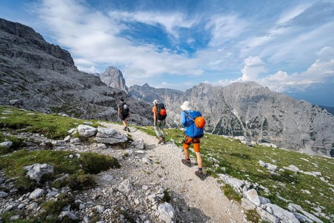 Three mountaineers on a hiking trail, rocky mountain landscape, Via Ferrata SOSAT via ferrata,