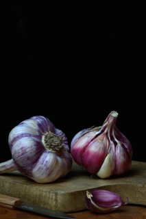 Fresh red garlic on chopping board, France