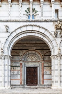Arched entrance portal of San Martino Cathedral, historic city centre, Lucca, Tuscany, Italy