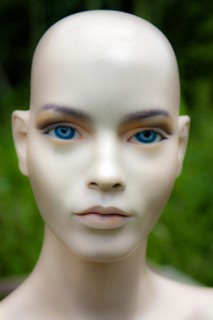 Female mannequin face doll model woman bald blue eyes close-up