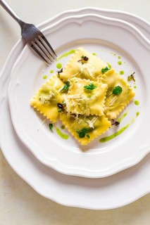 Ravioli with spinach and cheese, green sauce, on a light background, selective focus, no people