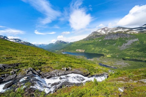 View of Innerdalen high valley with mountain landscape and lake Innerdalsvatna, waterfall on the