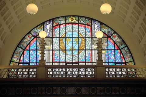 Colorful stained glass window with city coat of arms with laurel wreath, handicrafts, stained