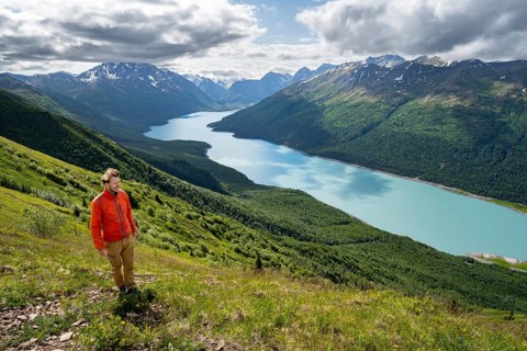 Mountaineer enjoys views of blue lake and mountains on Twin Peaks Trail, Eklutna Lake, Chugach