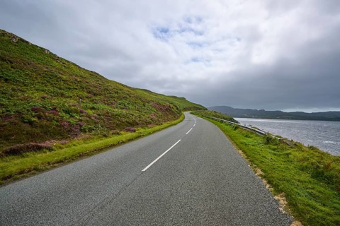 Road along a hill overlooking sea and cloudy sky, Isle of Skye, Scotland, United Kingdom, United