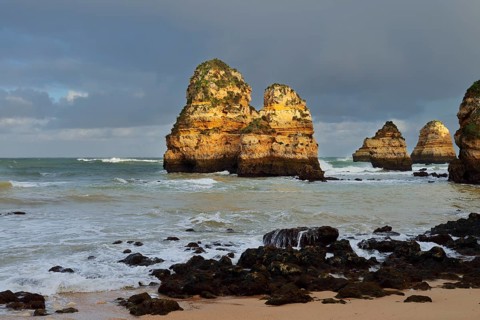Rock formations on the coast in the evening light, Praia do Camilo, Lagos, Algarve, Portugal