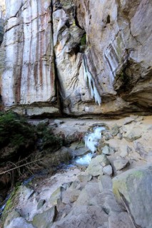 Frozen waterfall with icicles in the Gautschgrotte, Hohnstein, Saxony, Germany