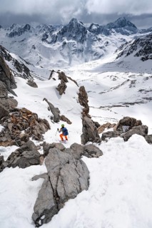 Mountaineer descending Piz Laviner, view of mountain panorama in wintry mountain landscape with
