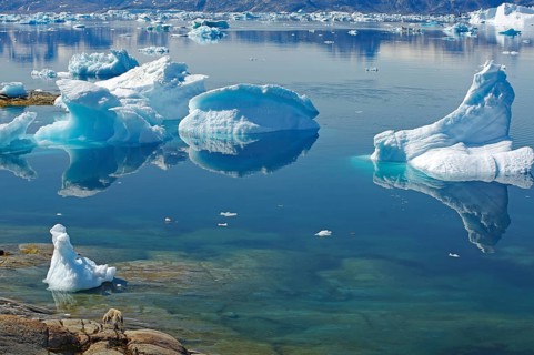 Majestic icebergs reflected in calm water, Tiniteqilaaq, Tasilaq, Arctic, Greenland, Denmark