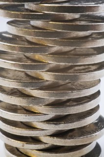 Close-up of evenly lopsided stack of US five cent coins on white background, Studio Composition,