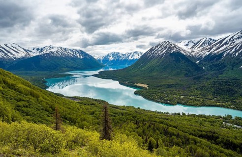 View of snowy mountains in spring and turquoise blue Kenai Lake, Slaughter Ridge Trail, Cooper