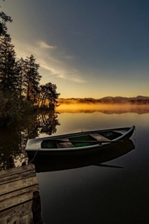 Boats in the autumnal Schmutter Weiher in the Allgäu near the municipalities of Halblech,