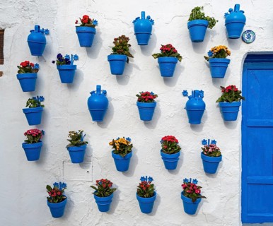 Blue flower pots on whitewashed wall, Castle of Iznajar, Castillo de Iznájar, Andalusia, Spain