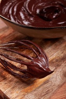 Metal whisk, close-up with chocolate dough, baking, structure and consistency, homemade, top view,