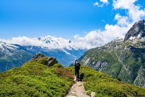 Mountaineers on hiking trail, mountain panorama with glaciated mountain peaks, glaciated summit of