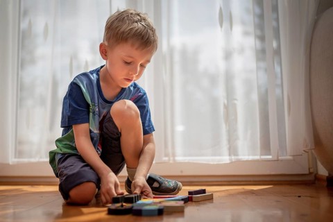 5-6 old boy play with blocks puzzle in Tymowa, Poland