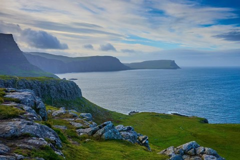 Cliffs by the sea with green areas under a dynamic sky, Waterstein Head, Waterstein, Isle of Skye,