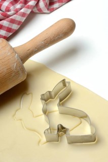 Rolled dough with bunny cookie cutter and rolling pin