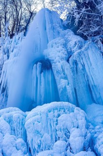 Urach waterfall full of bizarre ice formations frozen at winter temperatures, Bad Urach, Swabian