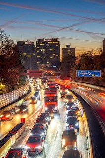 Evening traffic, partly with traffic jams, slow-moving traffic on the A40 motorway, Essen skyline,