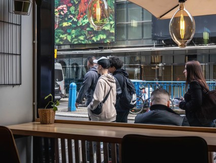 View through the window of a café of passers-by on Friedrichstraße in Mitte, Berlin, Germany