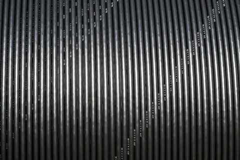 Black broadband cable on a spool, Oberweser, Weser Uplands, Weserbergland, Hesse, Germany