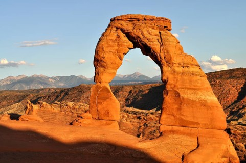 The Delicate Arch when the sun is low with mountains in the background, Arches National Park, Utah,