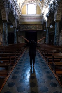 Woman Standing with Arms Outstretched Inside the Beautiful Church in Switzerland