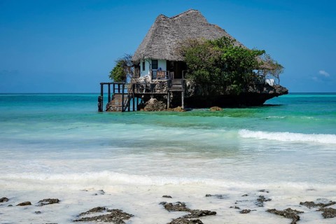 Scenic view of the building perched on a coral rock in the turquoise waters of the Indian Ocean
